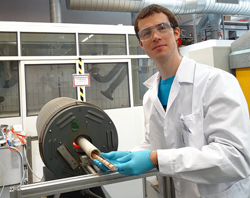 Empa scientist Lukas Huber introduces resins in the tube furnace.